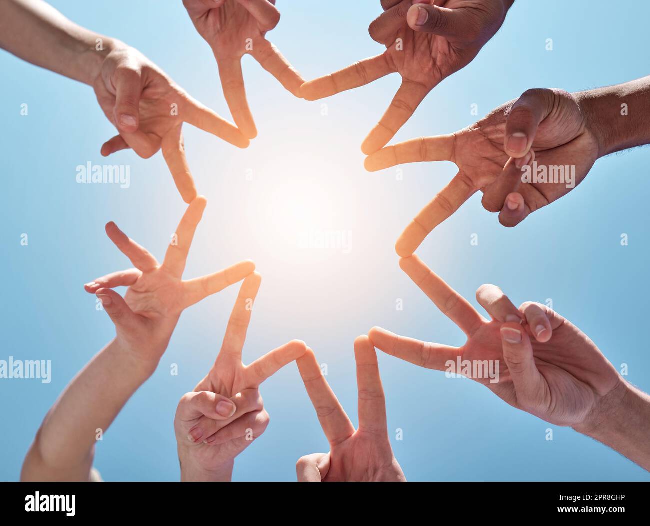 You shine as bright as a star. a group of unrecognizable people making a star shape with their fingers. Stock Photo