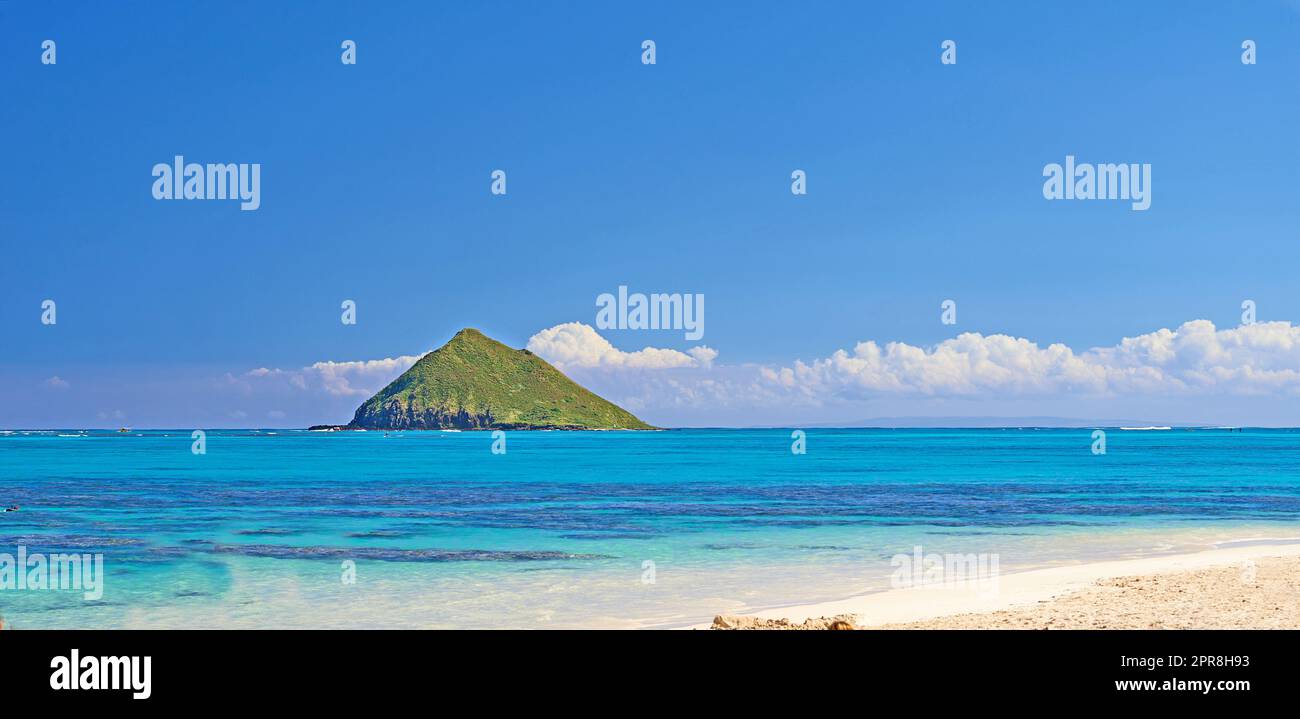 Lanikai Beach is located in Lanikai, meaning heavenly sea in Hawaiian is a neighborhood within Kailua, on the windward coast of Oahu, Hawaii. This small 12 mile beach has been consistently ranked among the best beaches in the world. Stock Photo