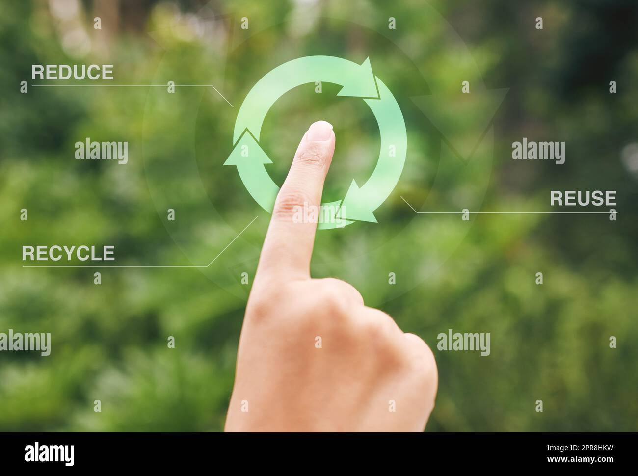 Finger selecting a digital recycle symbol. A digital recycling button being pressed by a person. Using technology to recycle, reuse and reduce waste. Stock Photo