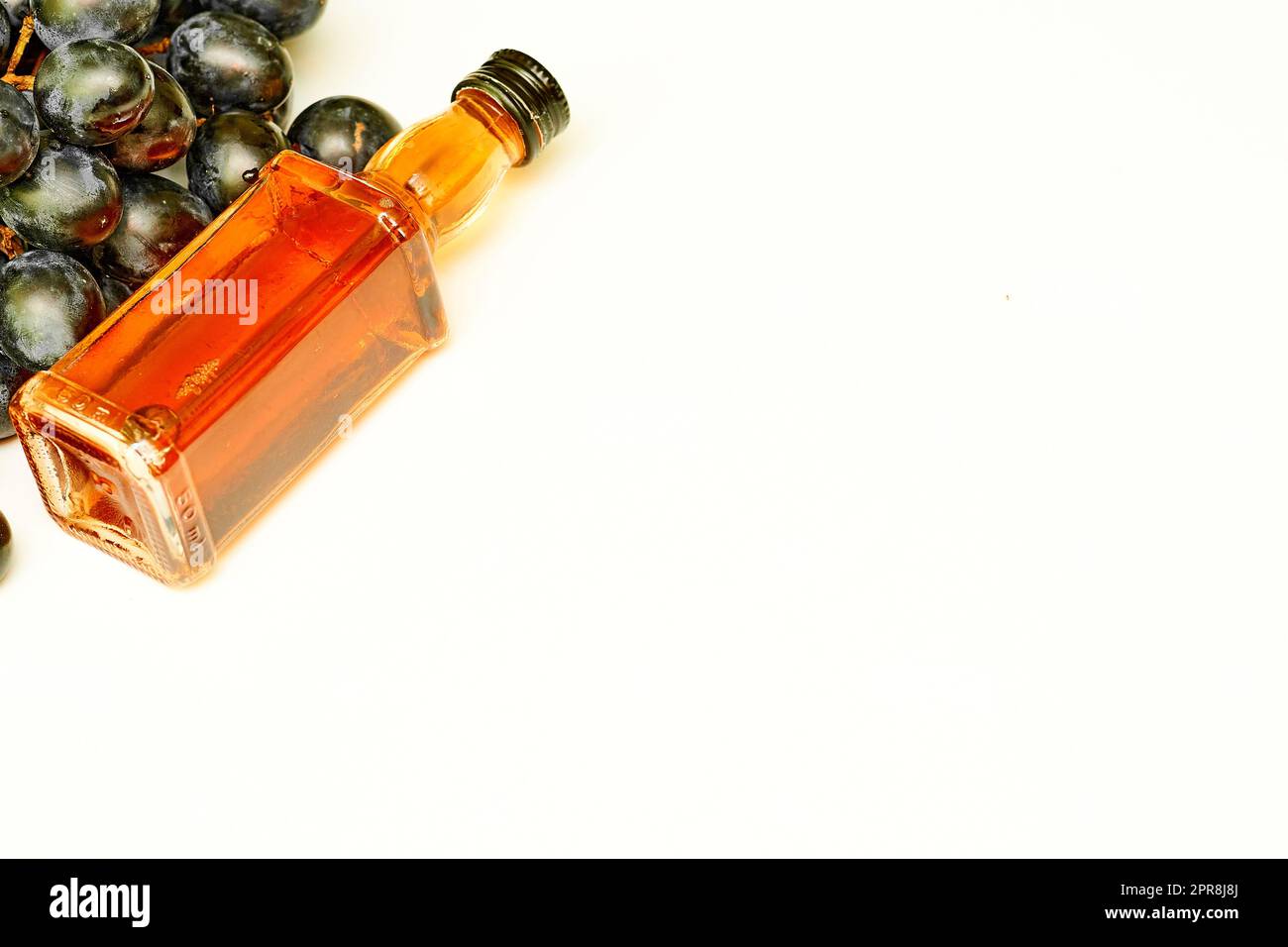 Good old brandy, cognac and black ripe grapes Stock Photo