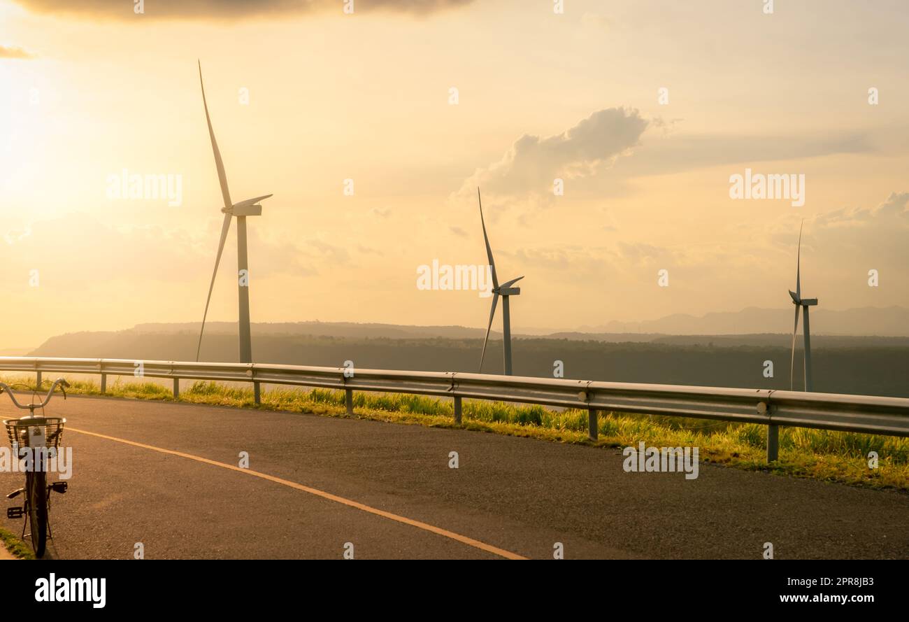 Wind energy. Wind power. Sustainable, renewable energy. Wind turbines generate electricity. Windmill farm on a mountain with blue sky. Green technology. Renewable resource. Sustainable development. Stock Photo