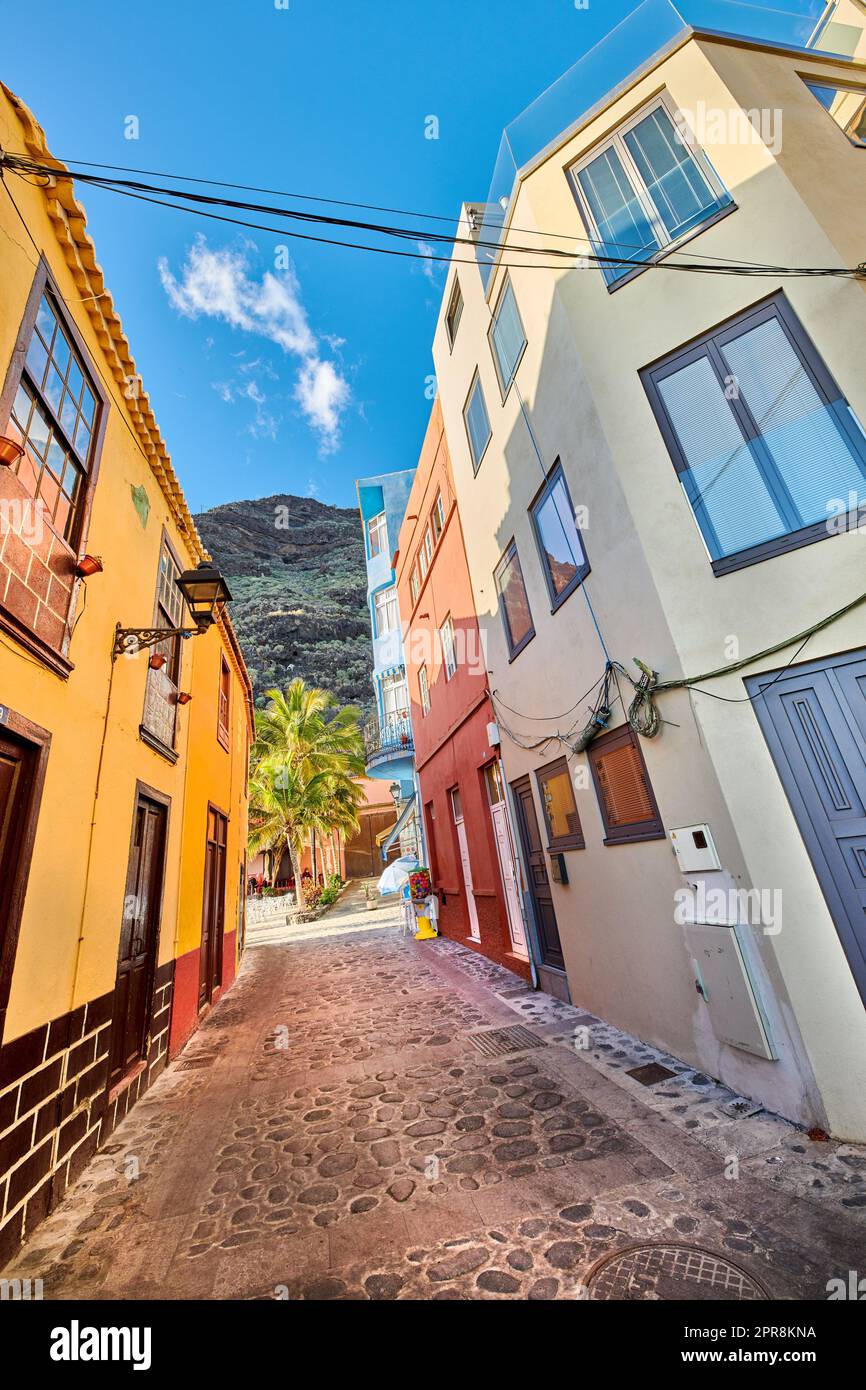 Scenic view of old historic houses, residential buildings, traditional infrastructure in small alleyway, street, road. Tourism, travel destination abroad and overseas in Santa Cruz de La Palma, Spain Stock Photo