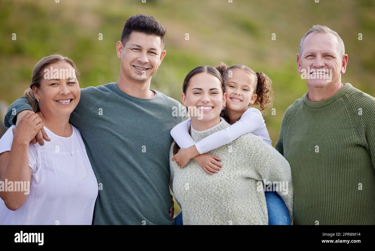 We love doing things together. a multi-generational family spending time together outdoors. Stock Photo