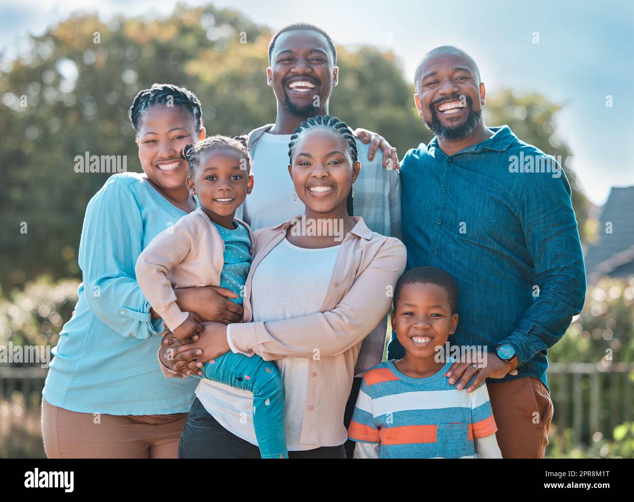 We love each other to bits. a multi-generational family standing together outside. Stock Photo