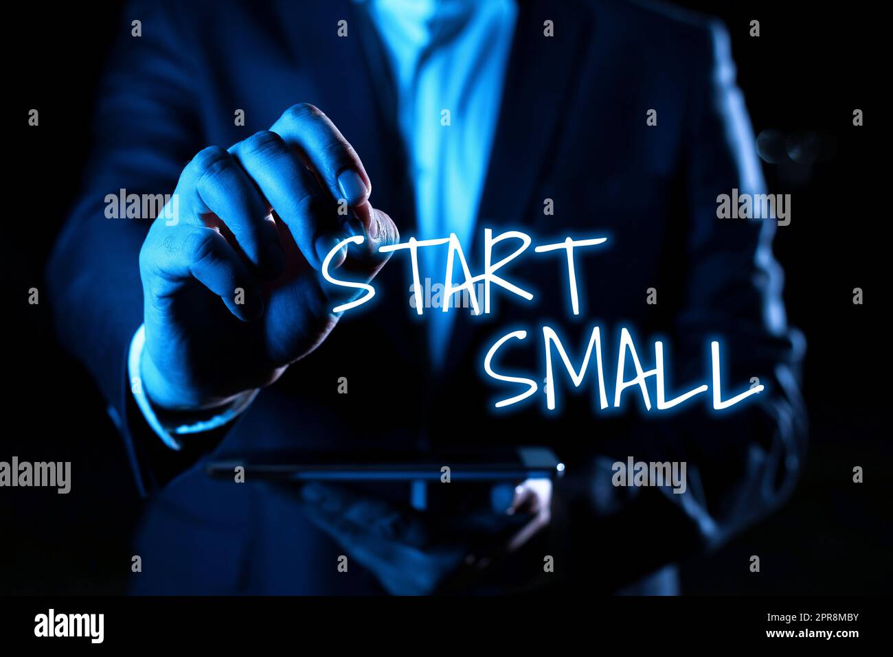 Hand writing sign Start Small. Concept meaning Small medium enterprises start up Business entrepreneurship Hand With Pen Pointing Important Infortmations With Other Holding Tablet Stock Photo