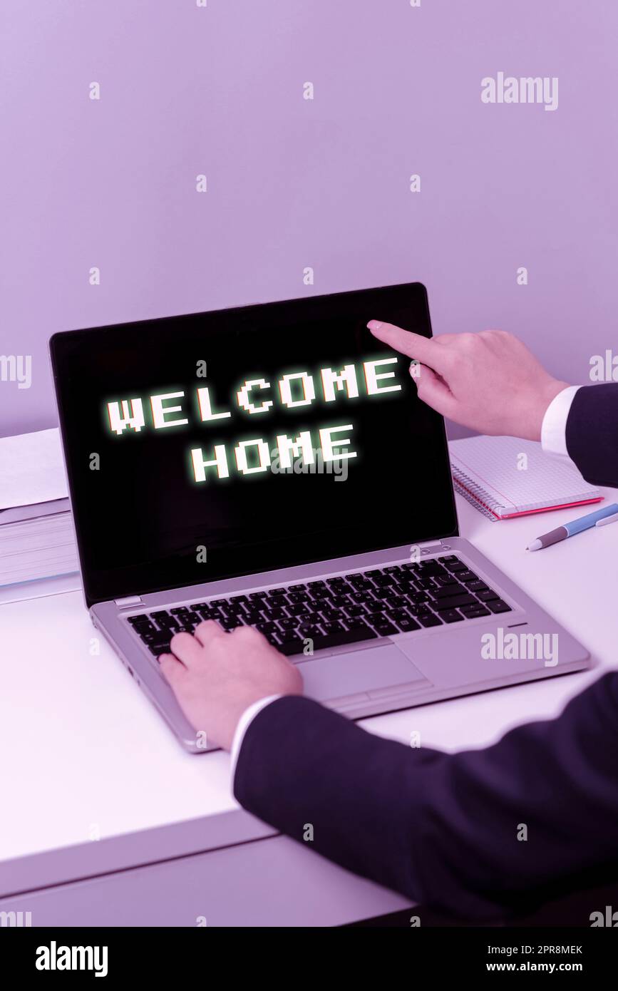 Conceptual caption Welcome Home. Business idea Expression Greetings New Owners Domicile Doormat Entry Woman Typing Updates On Lap Top And Pointing New Ideas With One Finger. Stock Photo