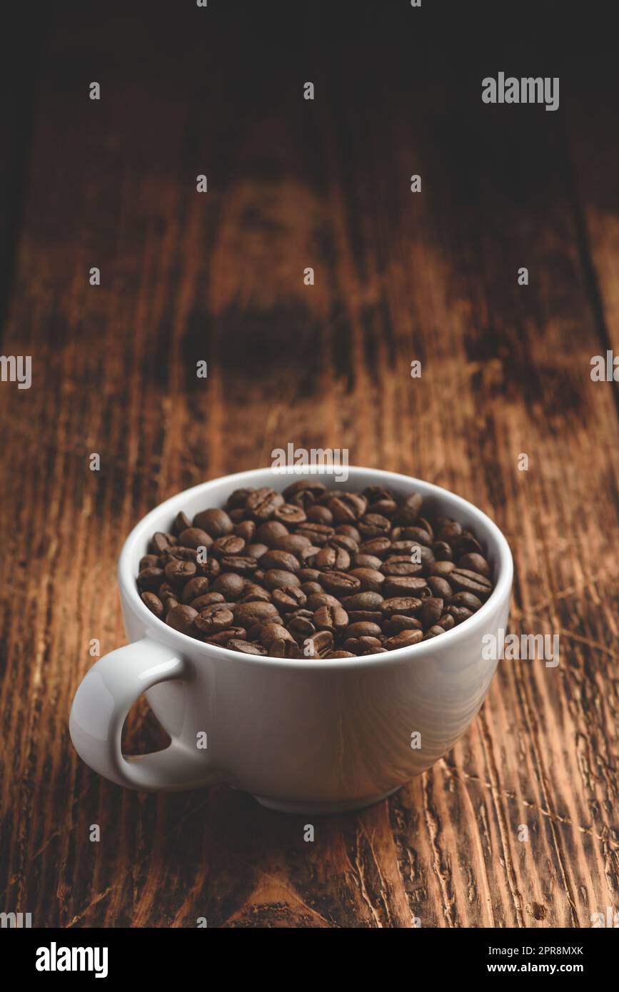Roasted coffee beans in cup Stock Photo Alamy