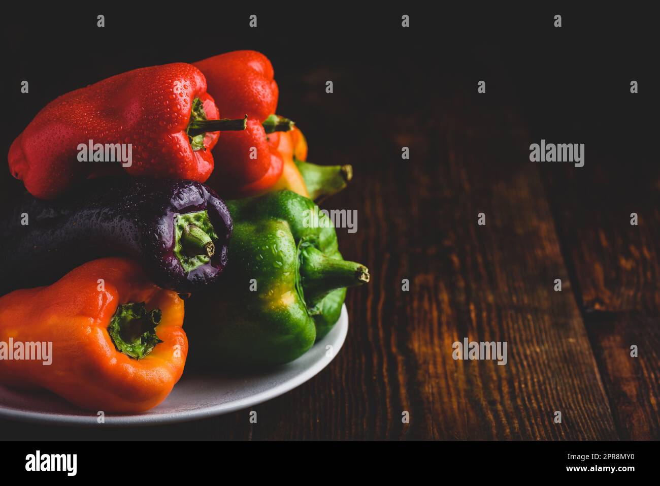 Fresh bell peppers on plate Stock Photo