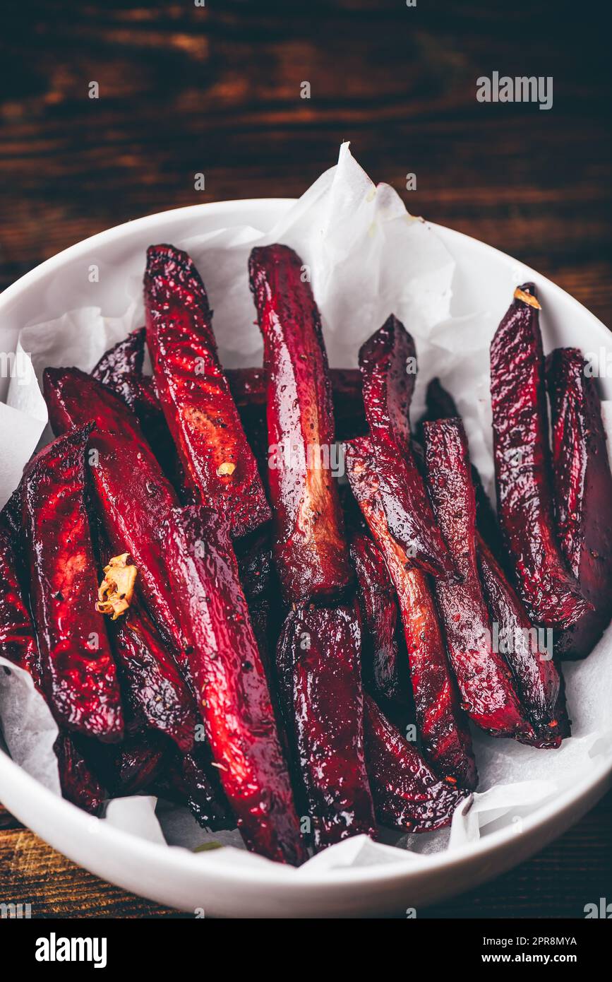 Oven baked beet fries in bowl Stock Photo