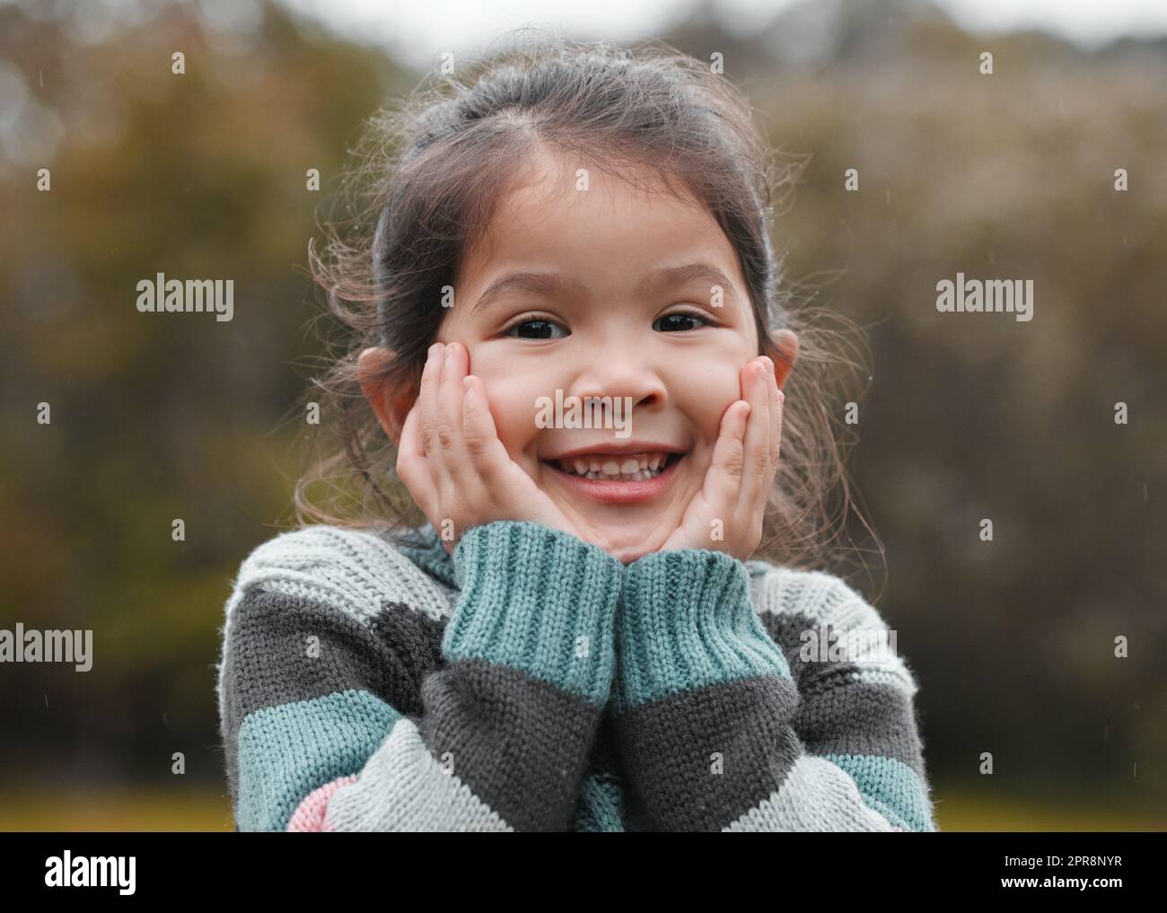 Can I go play now. an adorable little girl standing alone in the park