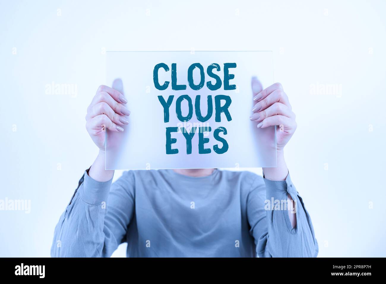 Hand writing sign Close Your Eyes. Word for Cover your sight we have a surprise for you do not peek Woman Holding Banner And Promoting The Company Brand To Achieve Goals. Stock Photo