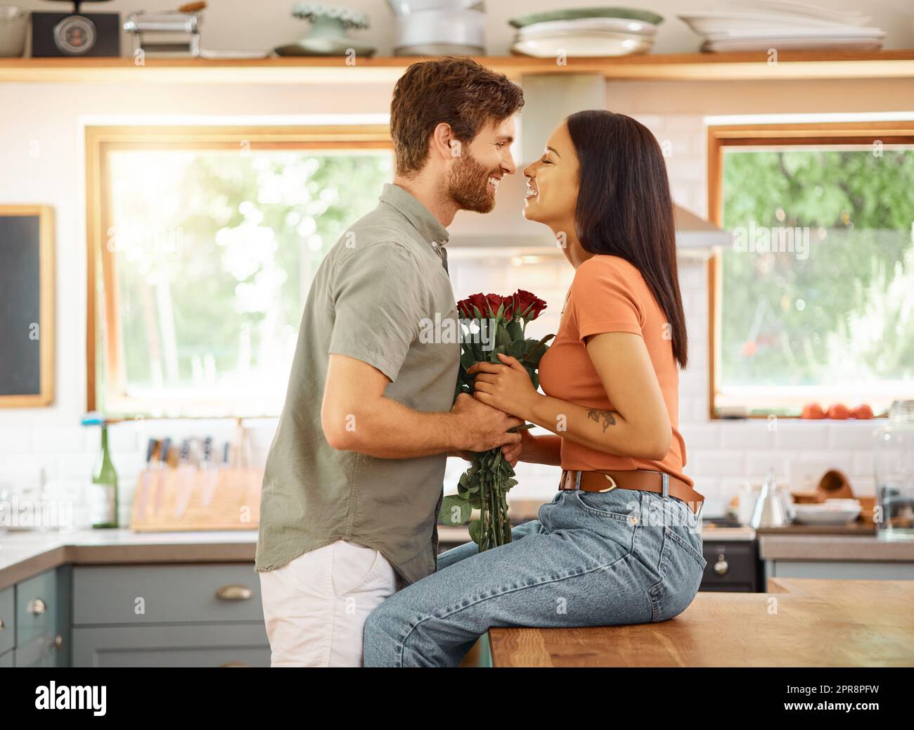 Young content caucasian boyfriend giving his cheerful mixed race