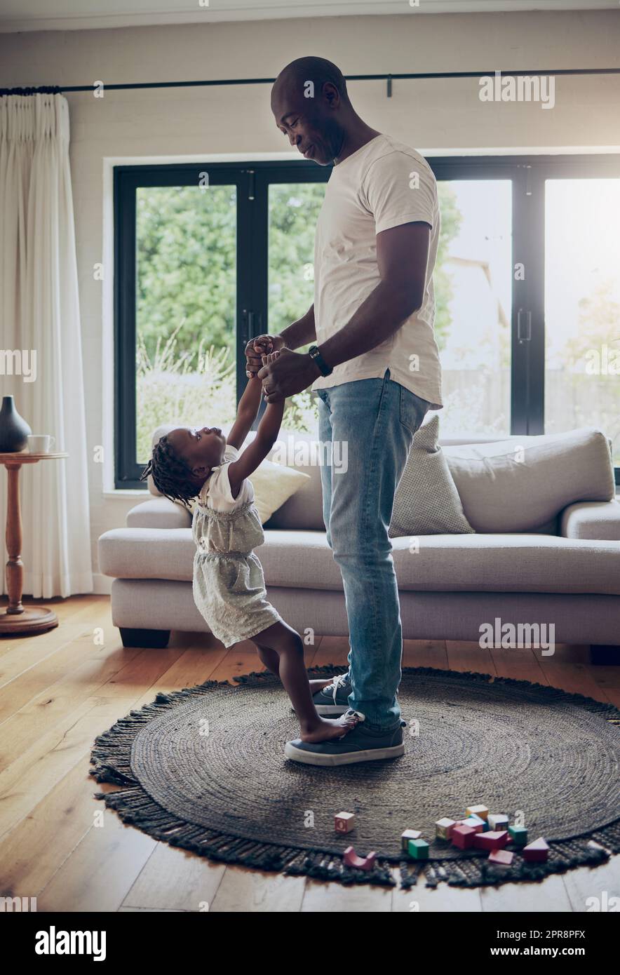 Can I have this dance. a little girl dancing with her father in the