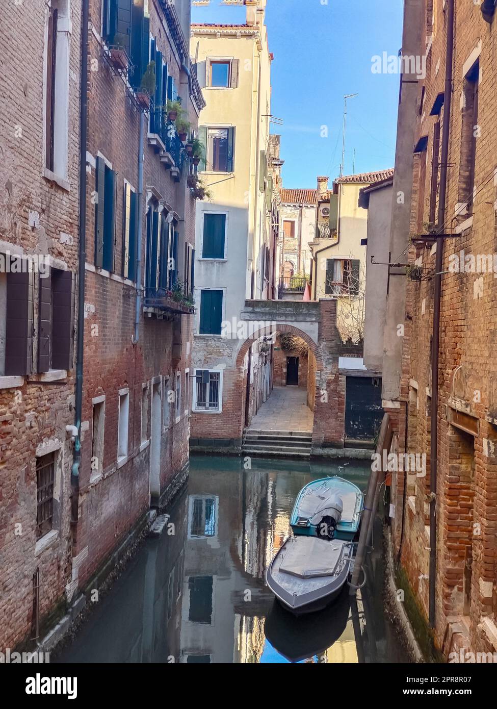 Canals of Venice in a sunny day with building in the street in the