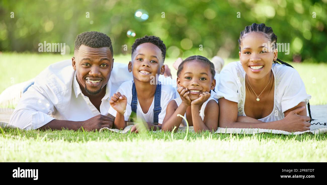 Nothing means more to us than being close to each other. a couple spending time outdoors with their two children. Stock Photo