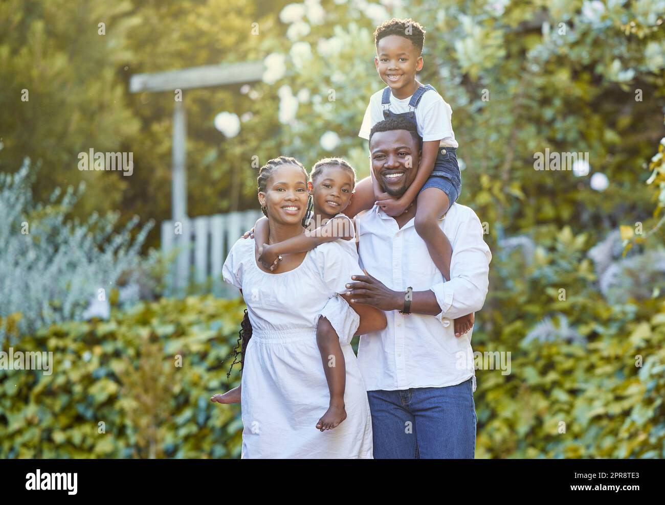 Our love gave us two beautiful kids. a couple spending time outdoors with their two children. Stock Photo