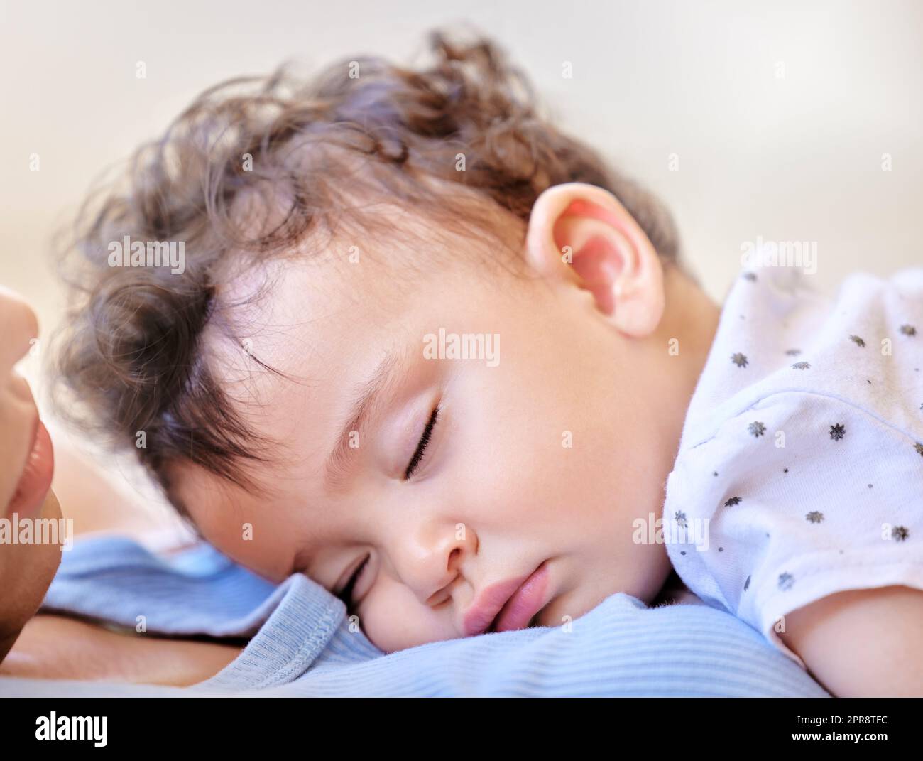 Little baby sleeping on mothers chest. Small girl asleep on her mom. Face of baby resting. Mother holding her sleeping child. Affectionate mother bonding with sleeping kid. Cute baby napping Stock Photo