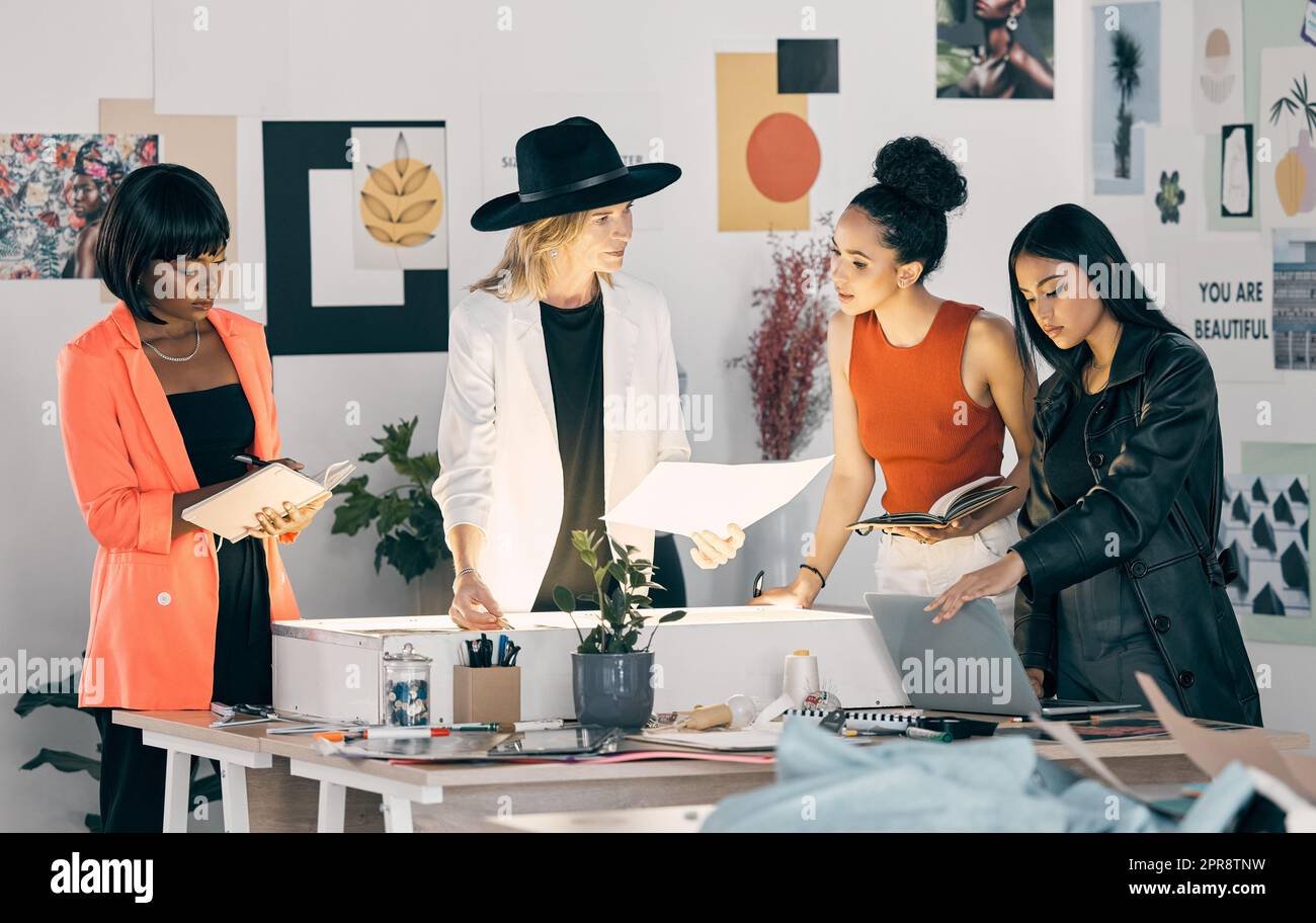 Last minute changes. a group of designers collaborating at a workshop together. Stock Photo