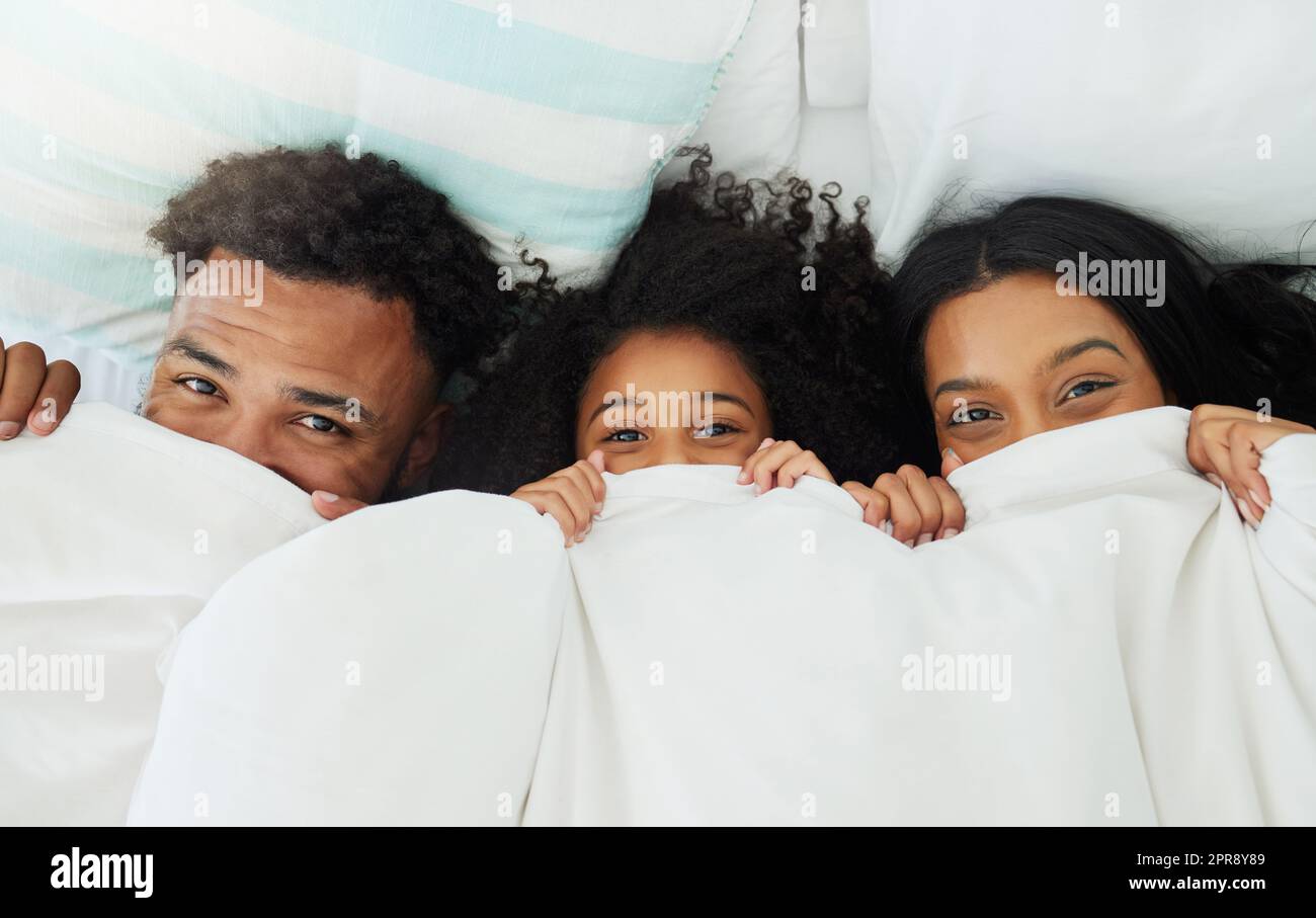Peekaboo, where are you. a young family relaxing at home. Stock Photo