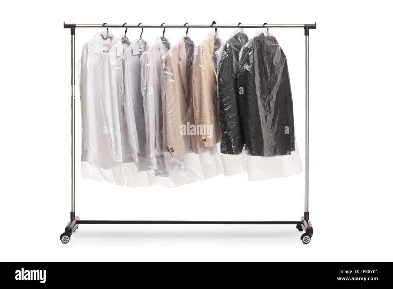 Clothing rack at dry cleaners with suits in plastic covers isolated on white background Stock