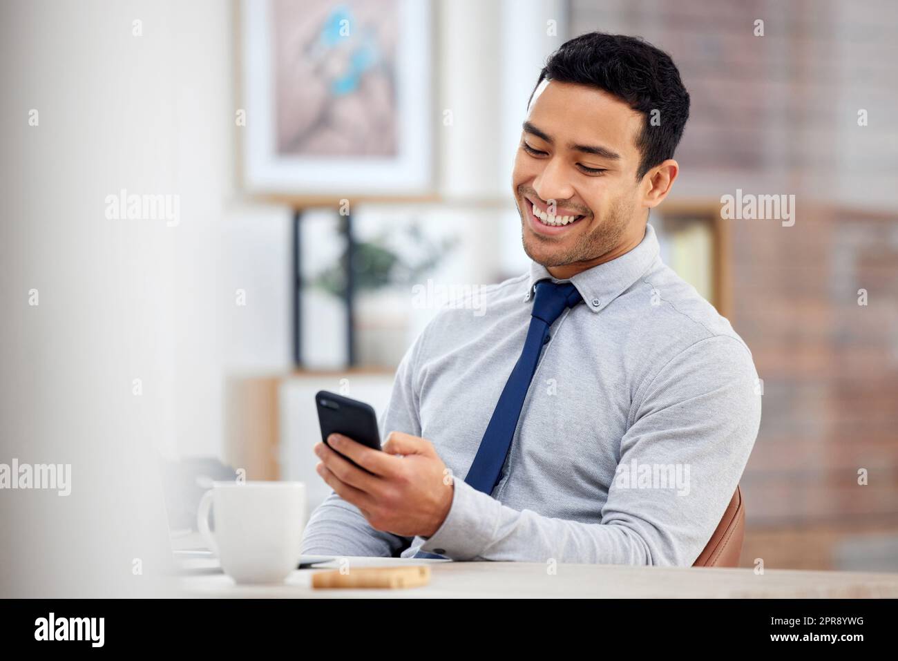 Phone, thinking and man by office window for career inspiration, job search  or online networking. Contemplating asian person or young entrepreneur  cellphone, smartphone or mobile app in workplace Stock Photo