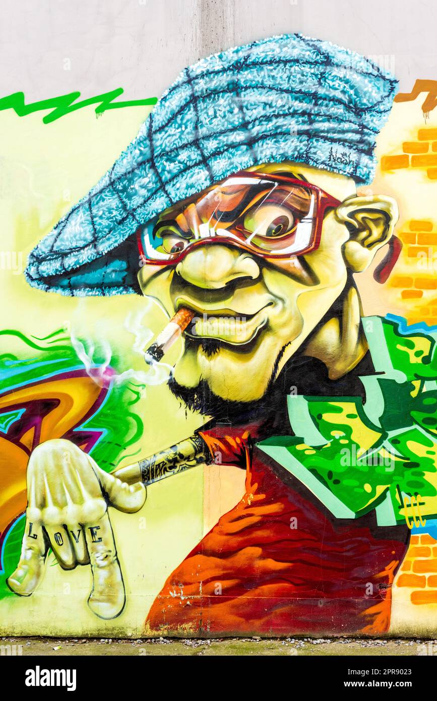 Artist man with beret graffiti urban street art on wall in Sofia