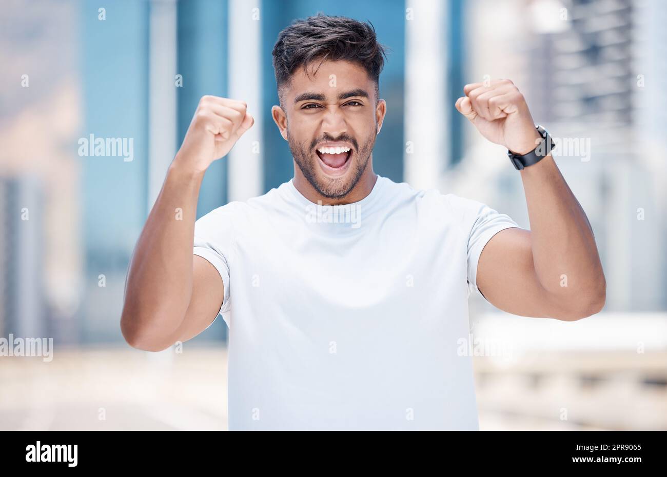 Young mixed race male athlete celebrating a goal, making a winner