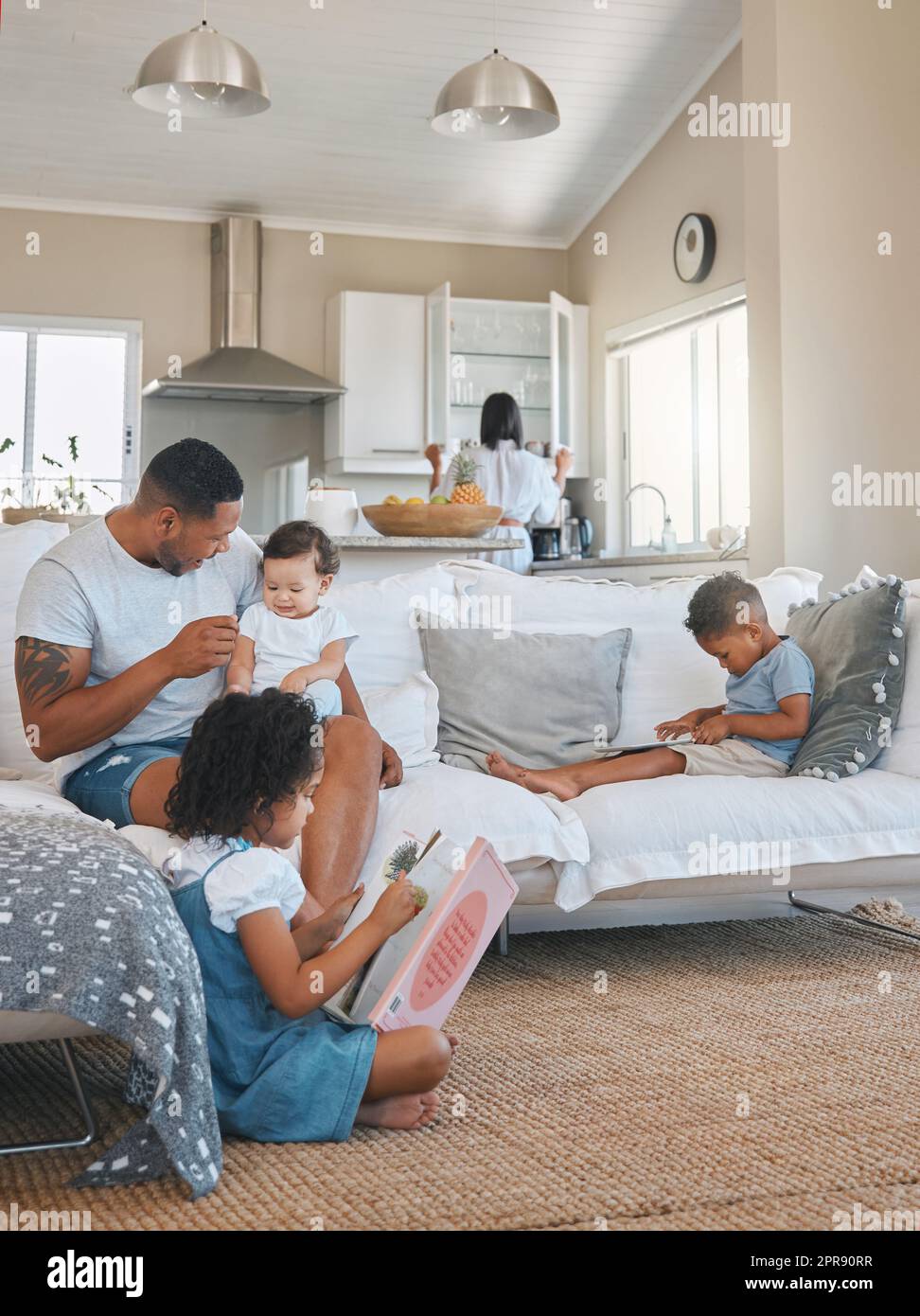 Typical Sundays. a young family relaxing together in the lounge at home. Stock Photo