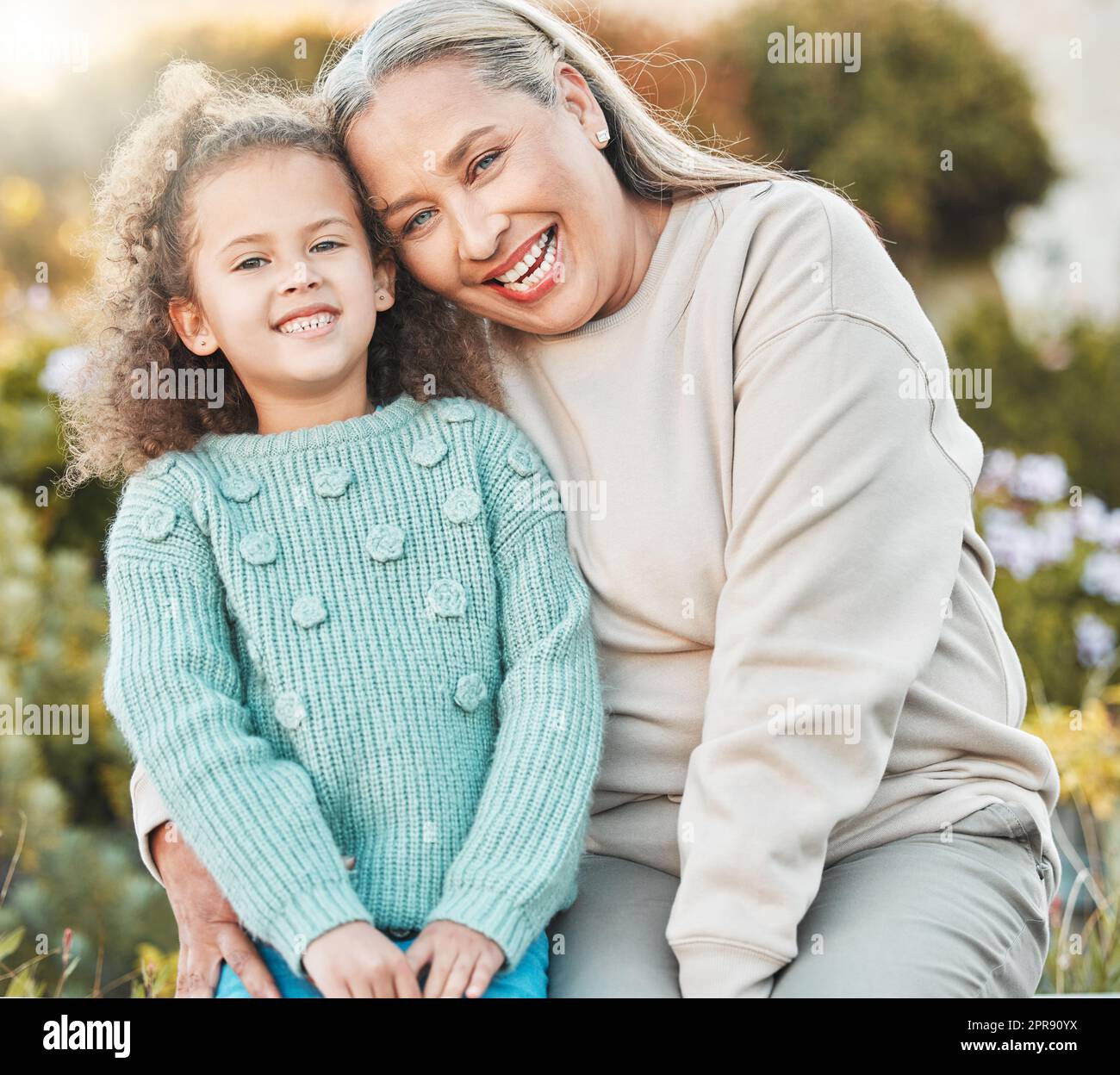 Family is your heart. a grandmother and grandchild spending time together in the garden at home. Stock Photo