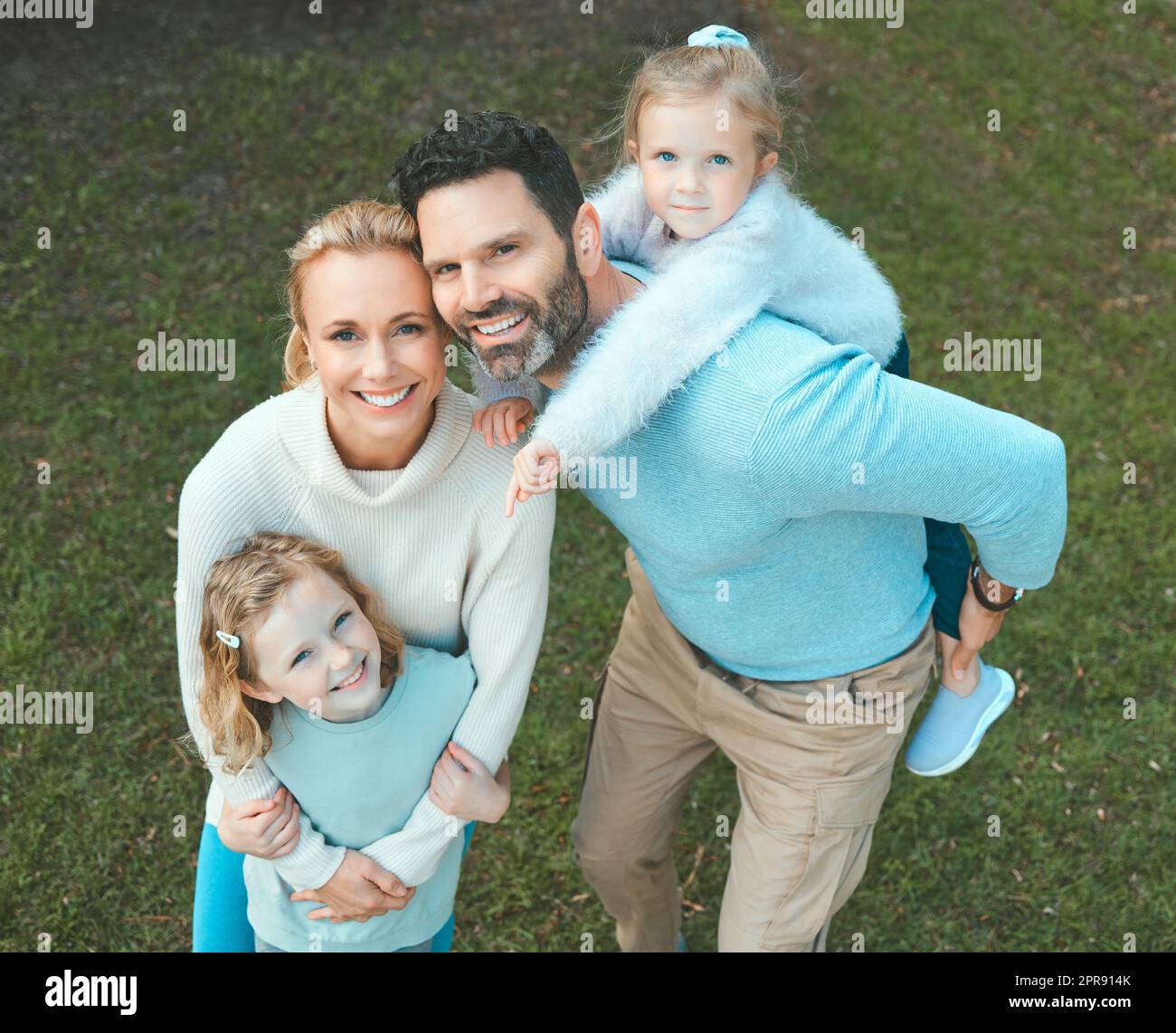 The heart of a family is the masterpiece of nature. a couple and their two daughters posing together in a park. Stock Photo