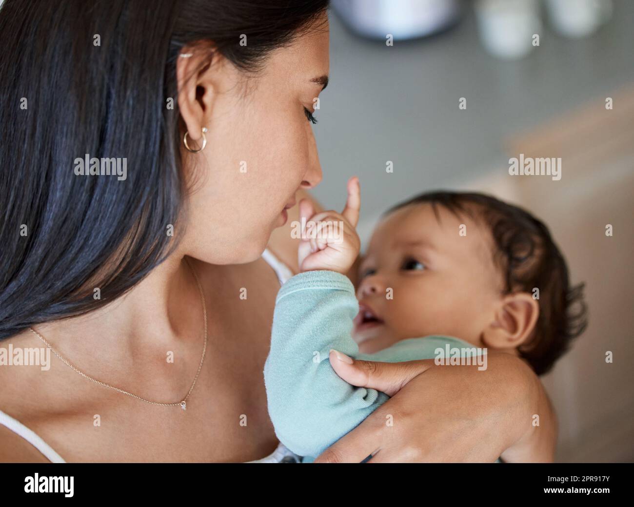 A touch on skin is felt in the heart. a young mother bonding with her ...