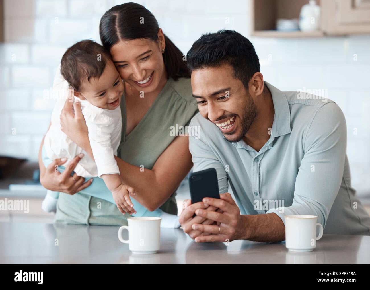 We just got exciting news. a young family spending time together at home. Stock Photo