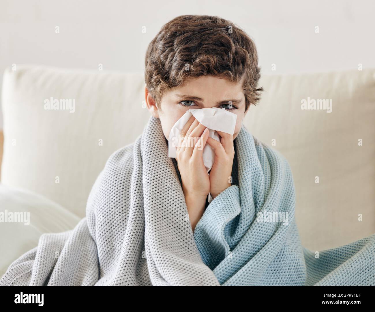 Allergies has its own schedule. a little boy blowing his nose and