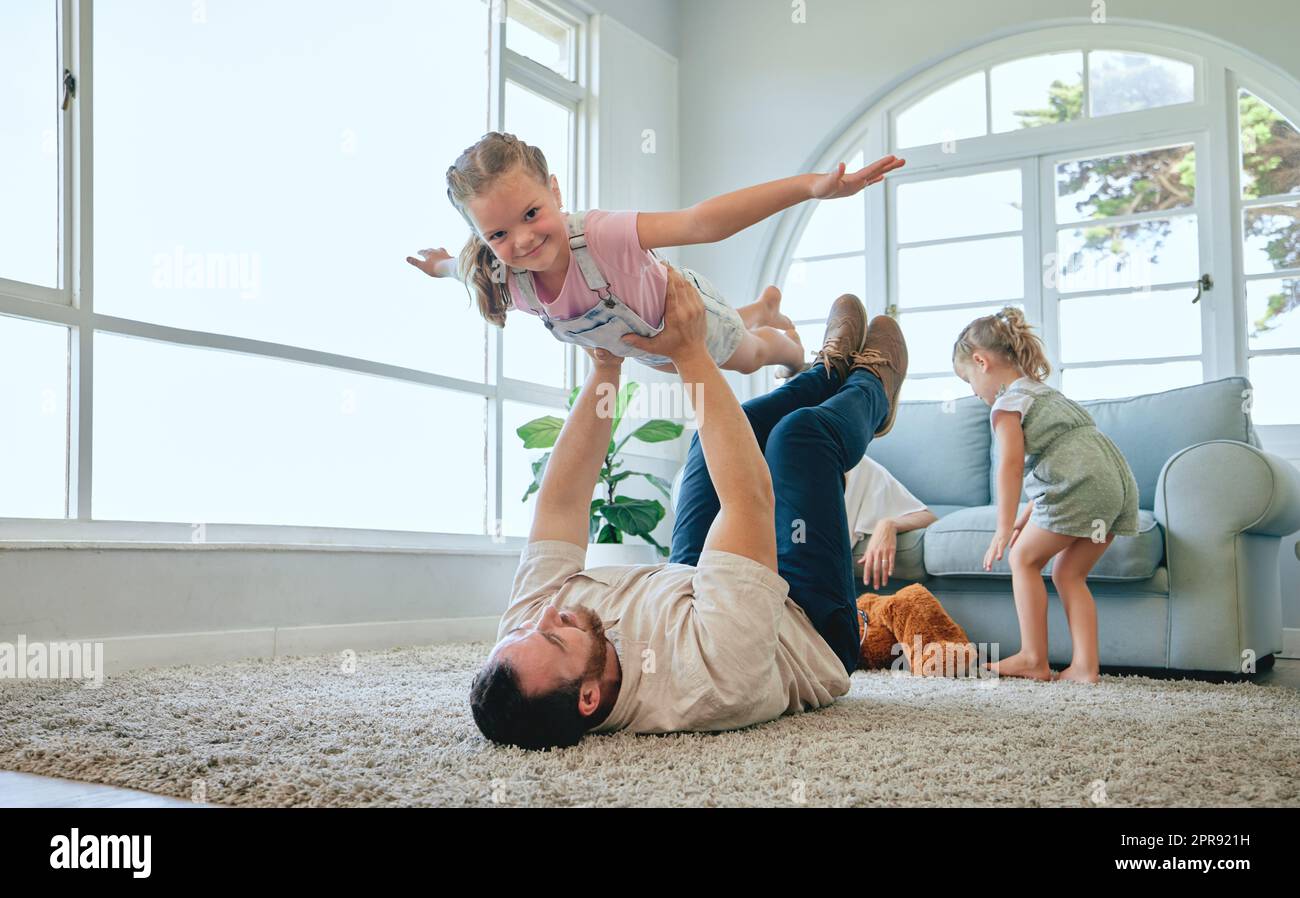 Fly as high as your wings take you. a young family relaxing at home. Stock Photo