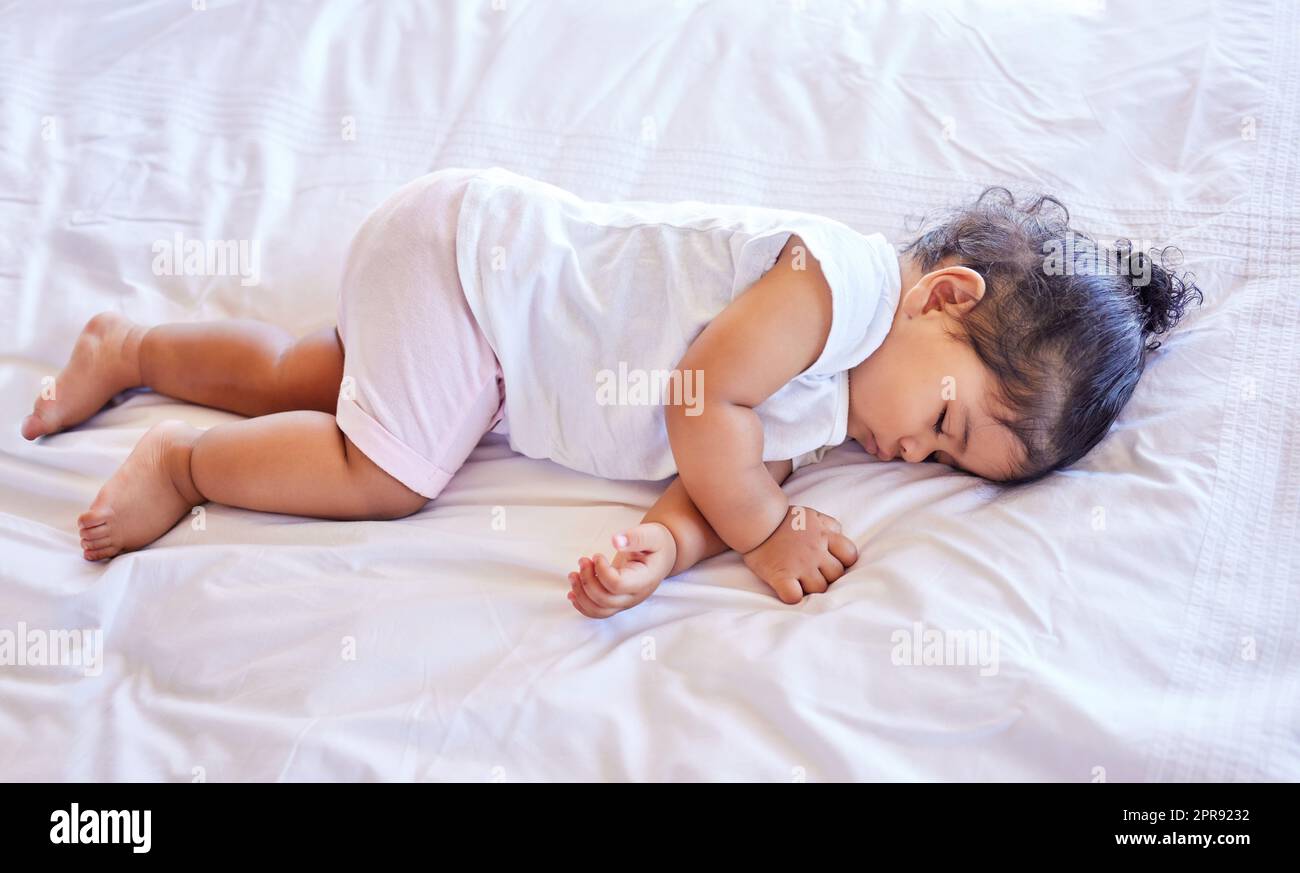 . Little baby girl sleeping on her bed. Toddler sleeping in her nursery