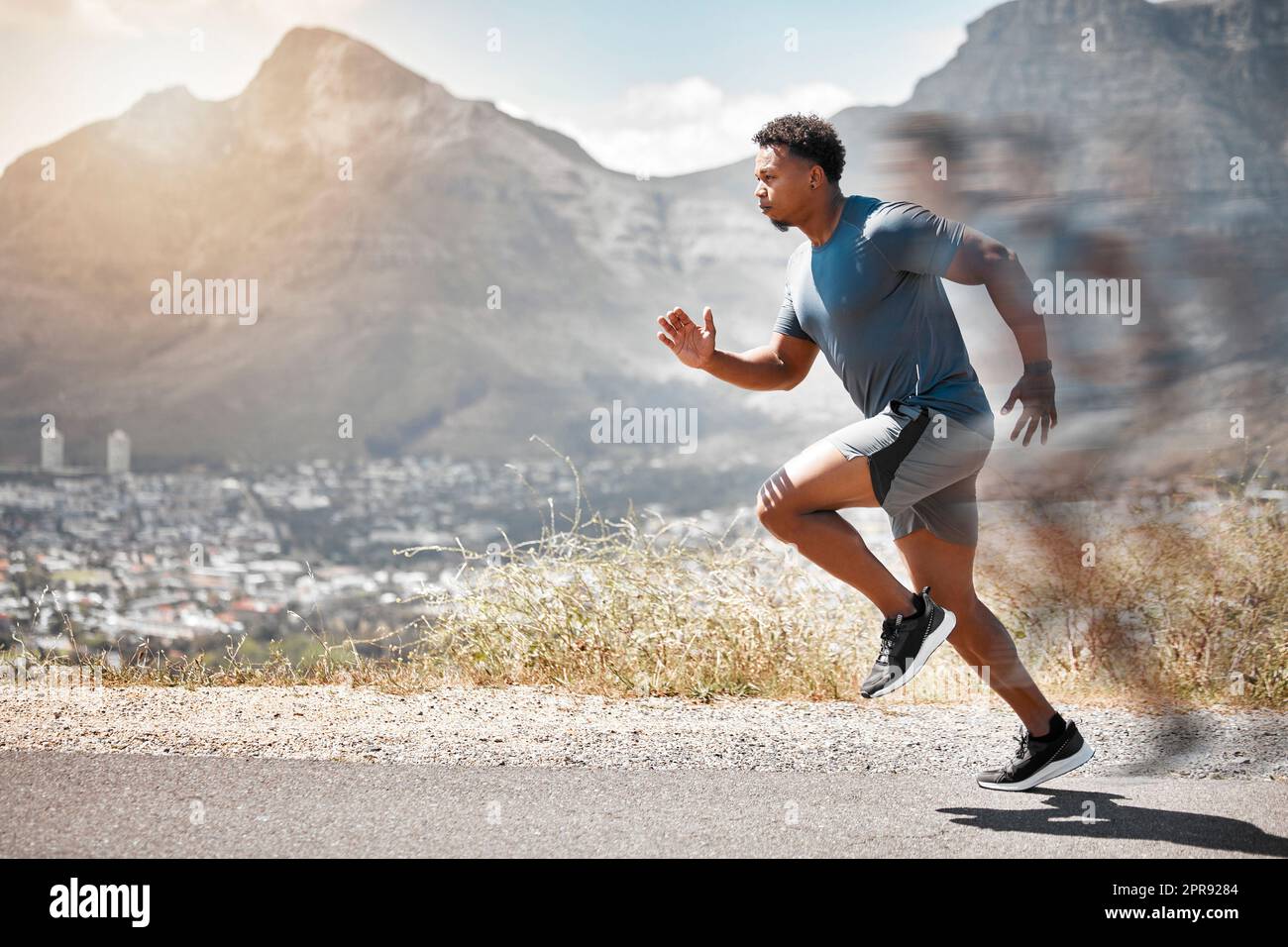Set goalposts while you run. a handsome young man running alone outdoors. Stock Photo