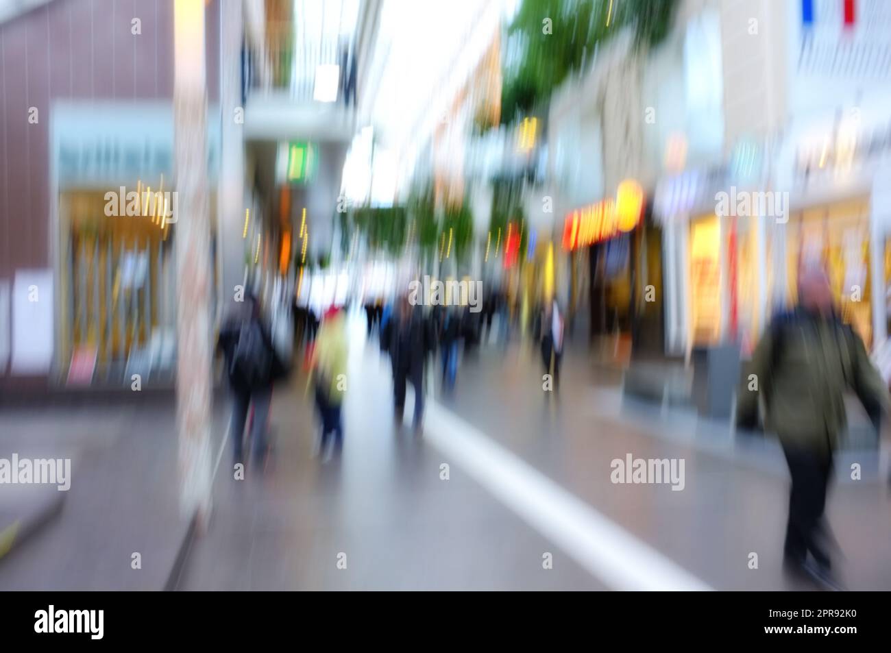Blurred motion of people traveling in a city outside. Defocused on crowd population of tourists, travelers and pedestrians exploring abroad while walking in a bustling and busy urban street downtown Stock Photo