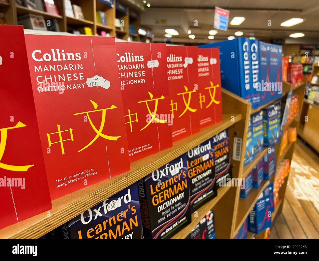 Shelves with colorful dictionaries and phrasebooks in a bookstore Stock