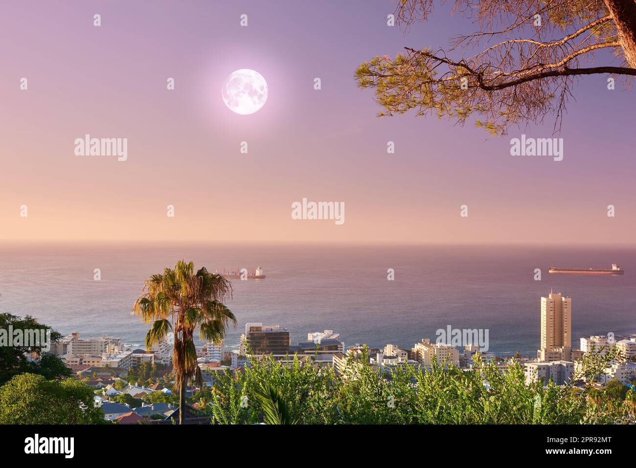 Beautiful landscape view of the sea and horizon from Signal Hill tourism location in Cape Town, South Africa. Stunning city and ocean with a full moon in a sunset sky background with copy space. Stock Photo