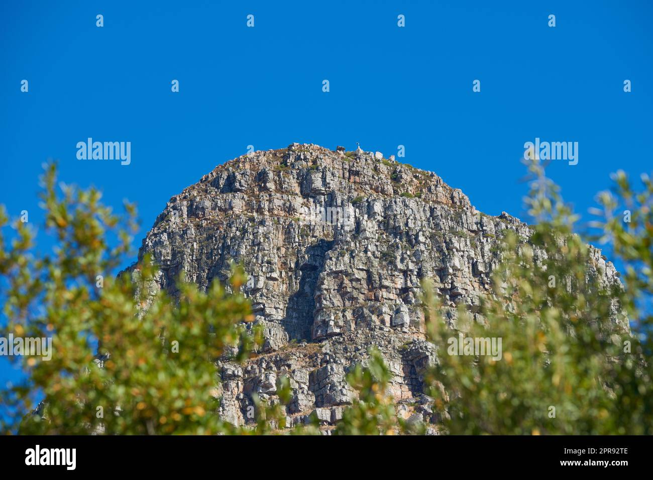 Landscape view of mountain, copy space and blue sky background from lush, green botanical garden or national park. Low angle of rough, rocky or dangerous terrain in remote location overseas or abroad Stock Photo