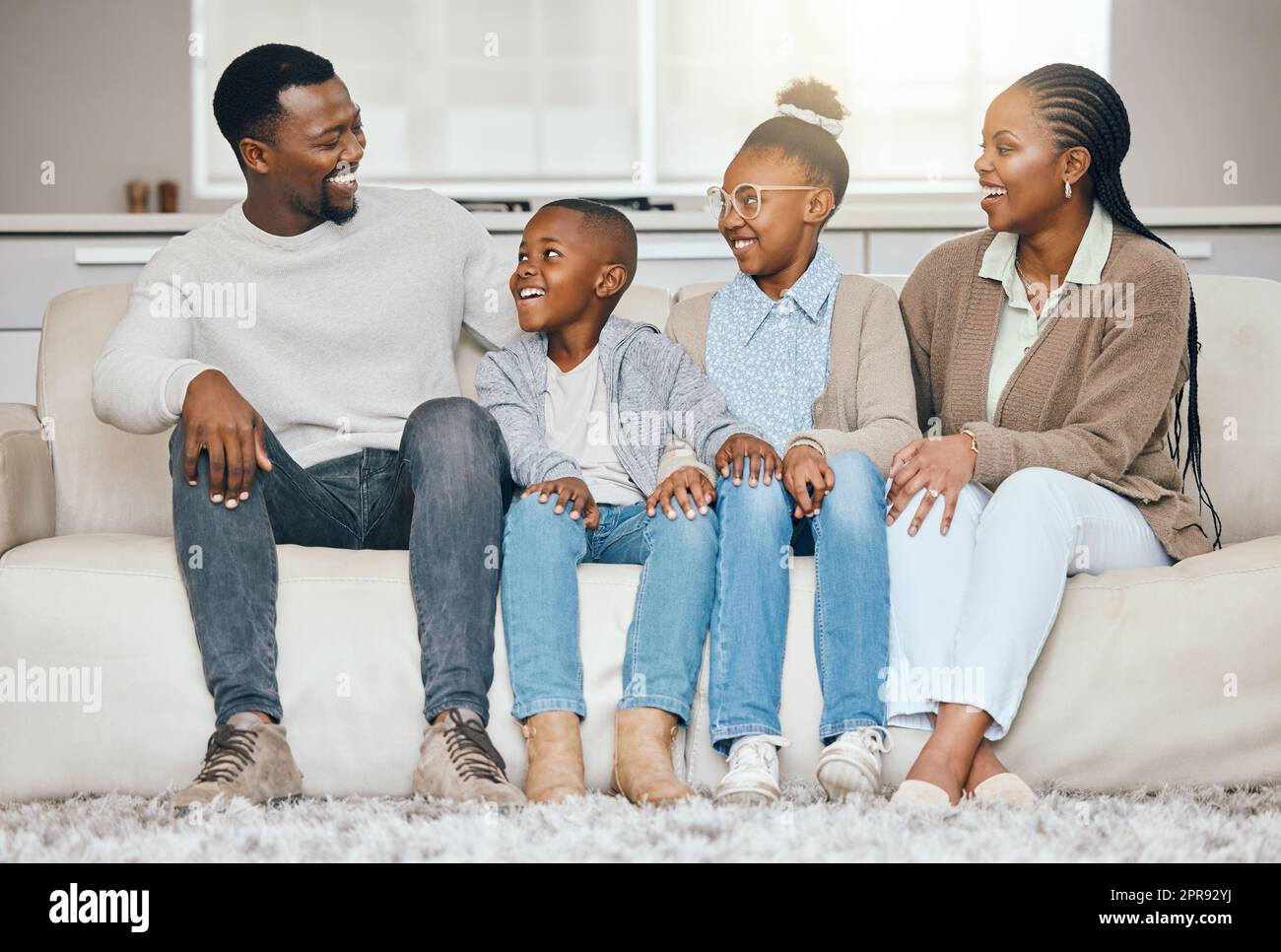 We admire him so much. a young family relaxing together at home. Stock Photo