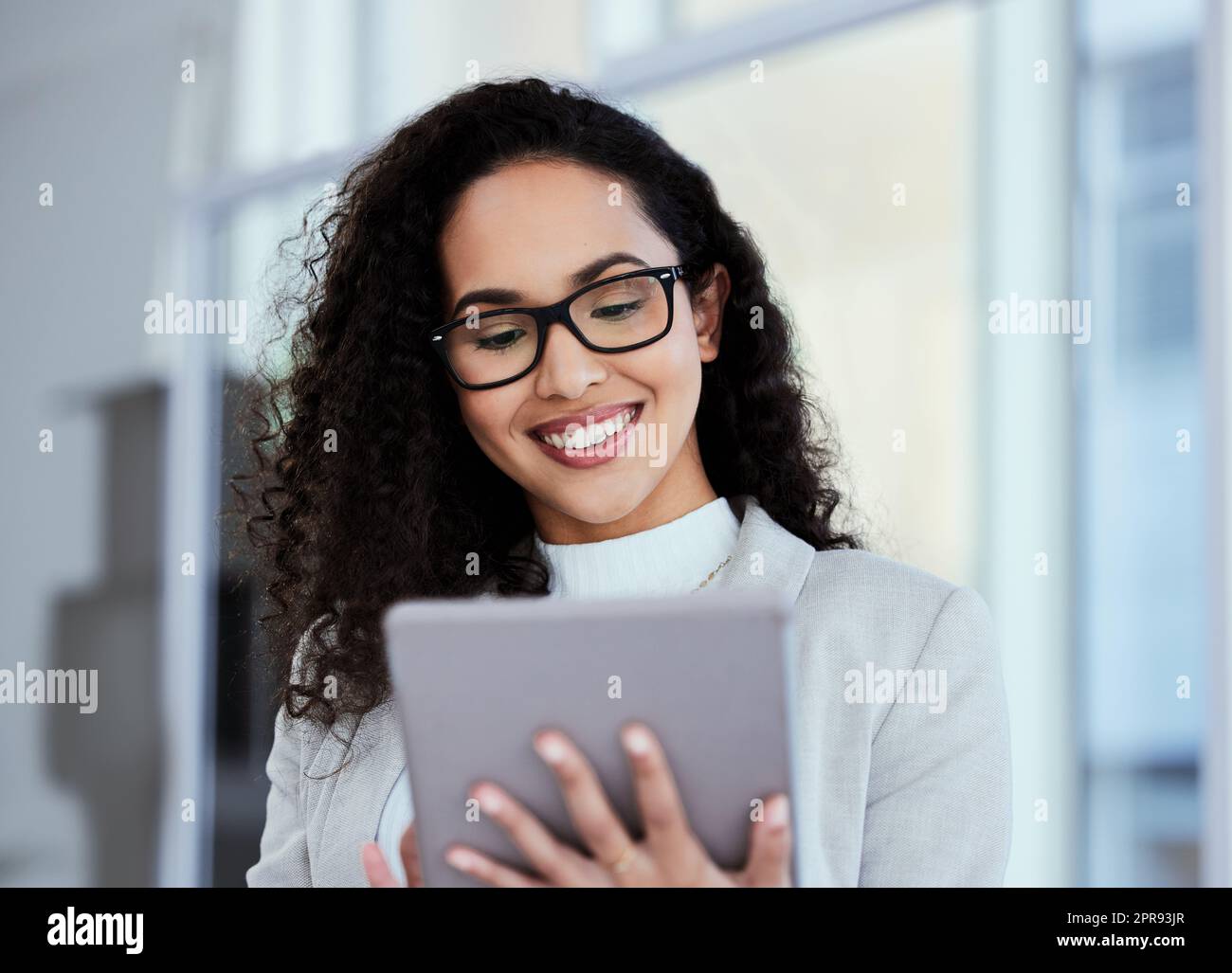 Responding to emails all day. a young businesswoman using her digital tablet. Stock Photo