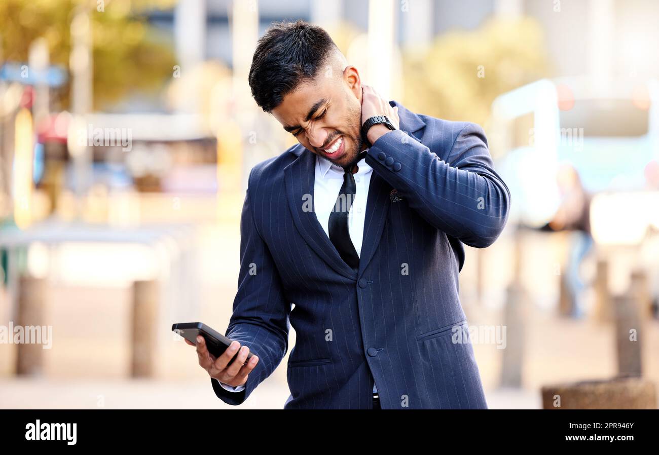I think i just pulled a muscle. a young businessman massaging his neck