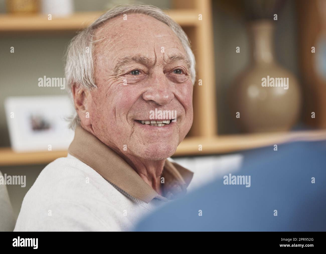 Hes happy to be getting some medical care. an elderly man having a checkup with an unrecognizable nurse at home. Stock Photo