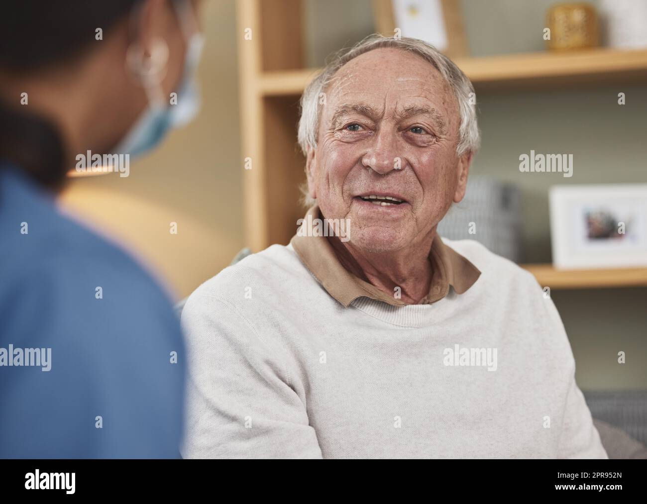 A happy and cared for patient. an elderly man having a checkup with an