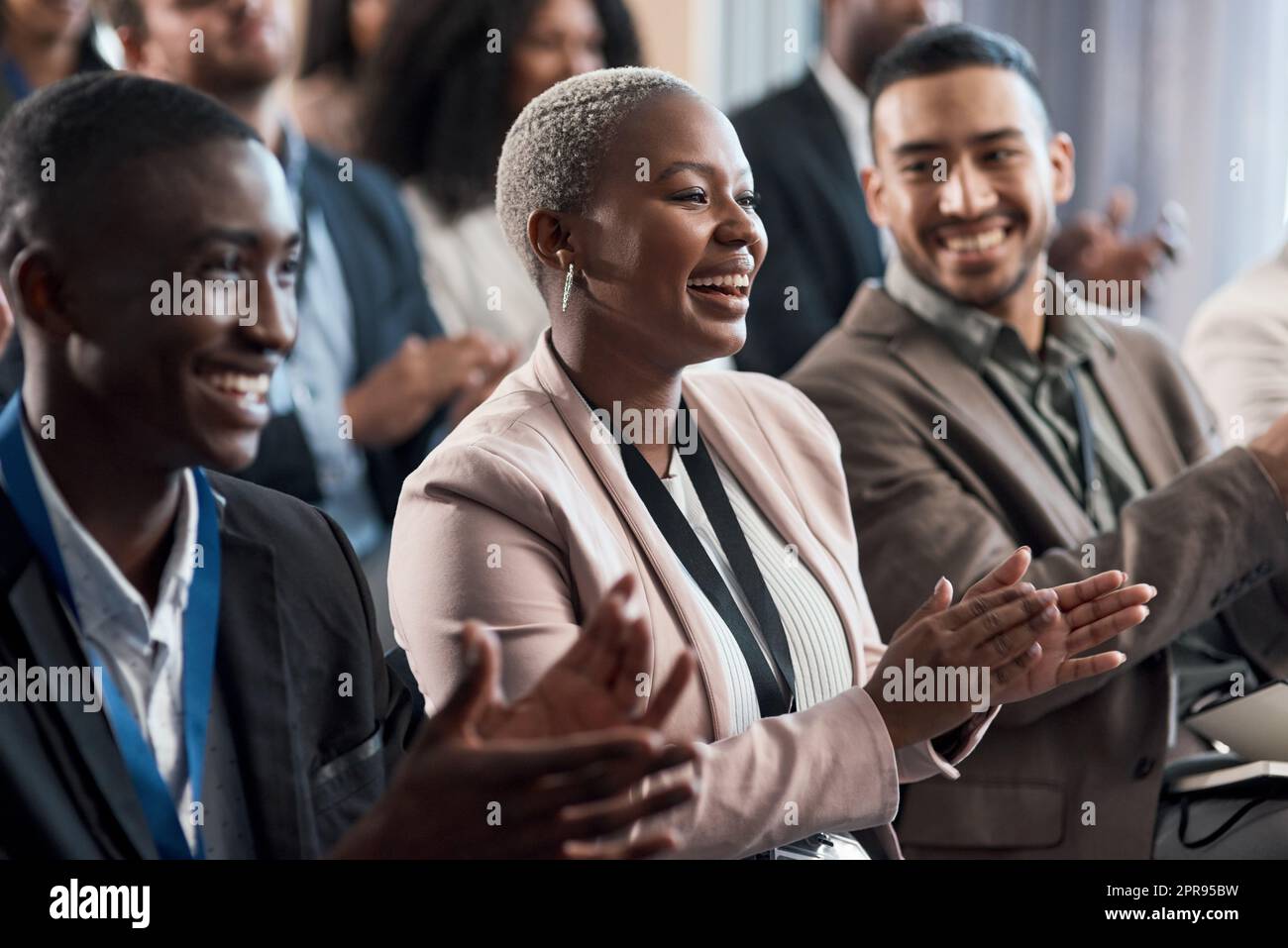 Represent your clique. a group of young businesspeople clapping during a conference in a modern office. Stock Photo