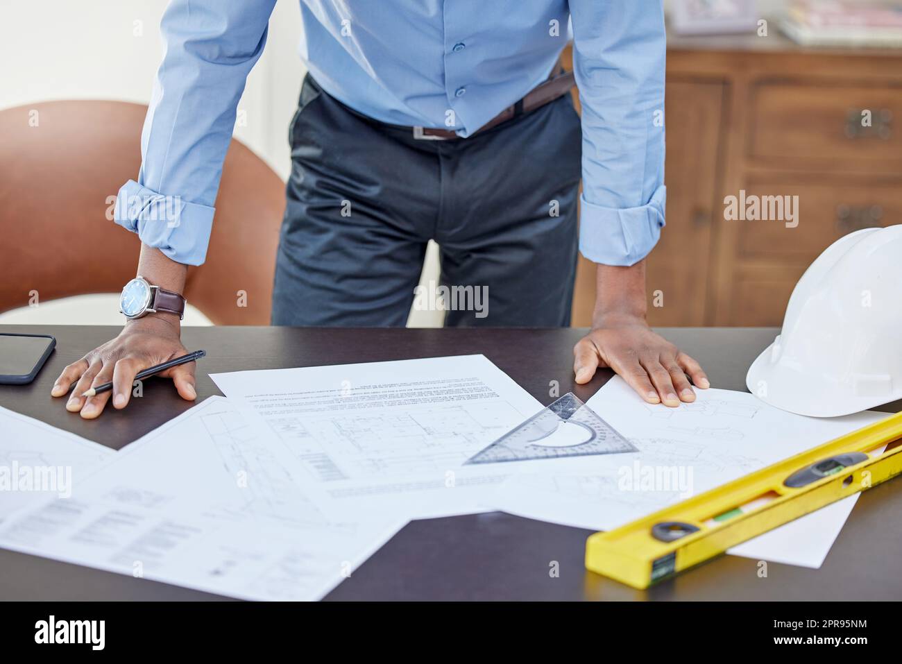 Challenges arent meant to break you but build you. an architect working on paperwork at his desk. Stock Photo