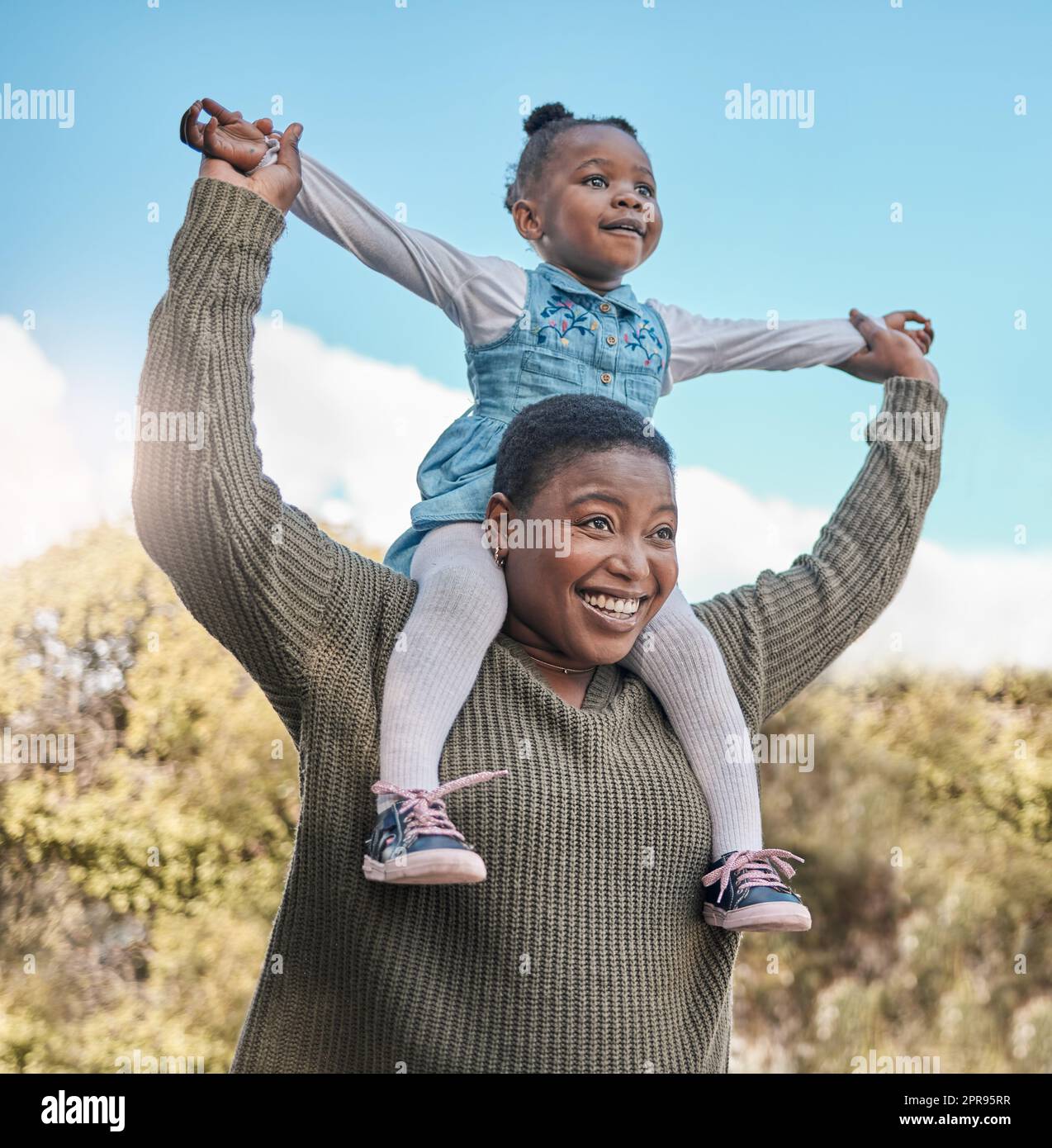 Its all smiles when theyre at the park. a mother carrying her daughter on her shoulders outdoors. Stock Photo