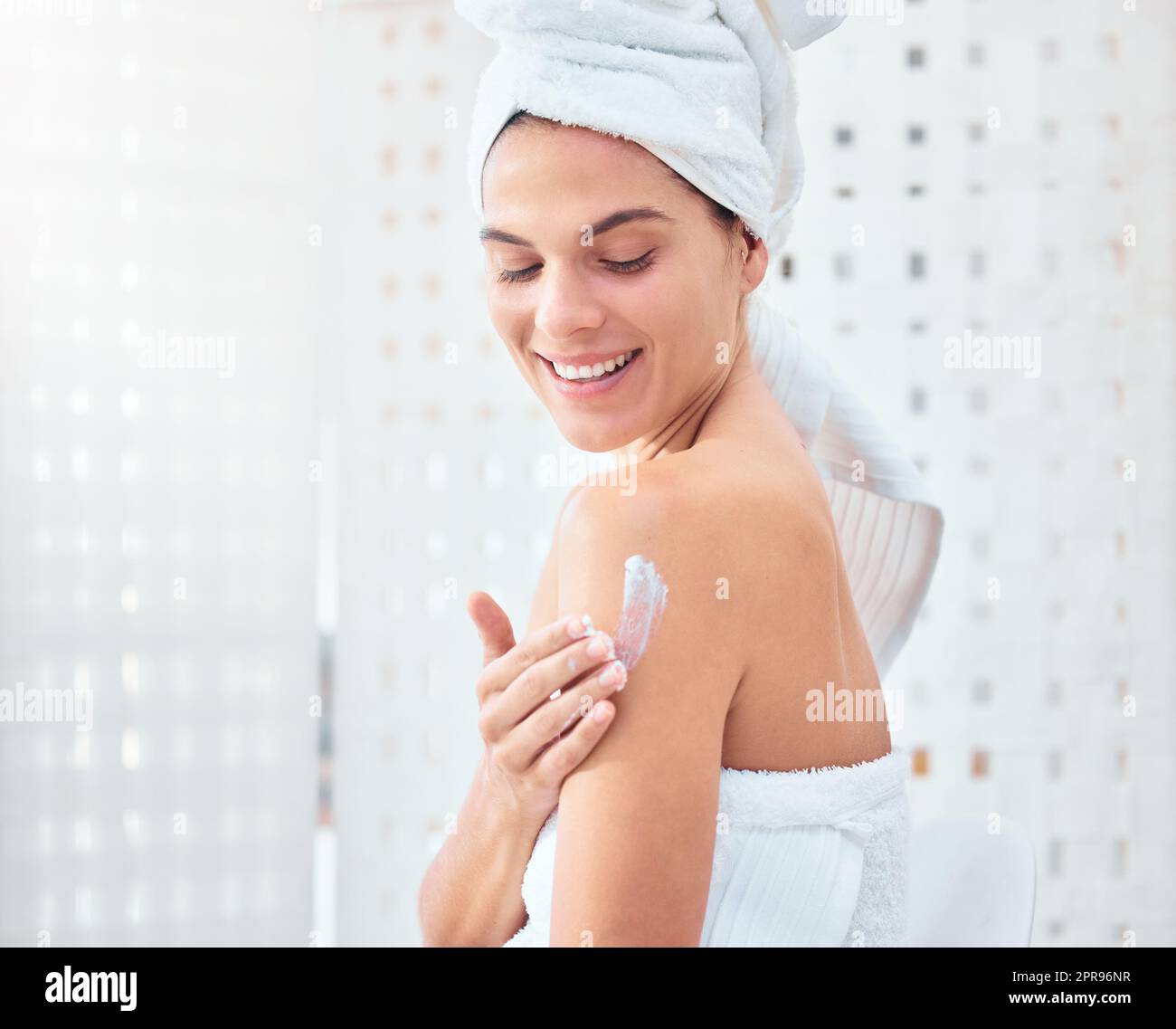 Soft skin brings me joy. a woman applying moisturiser to her arms and shoulders. Stock Photo