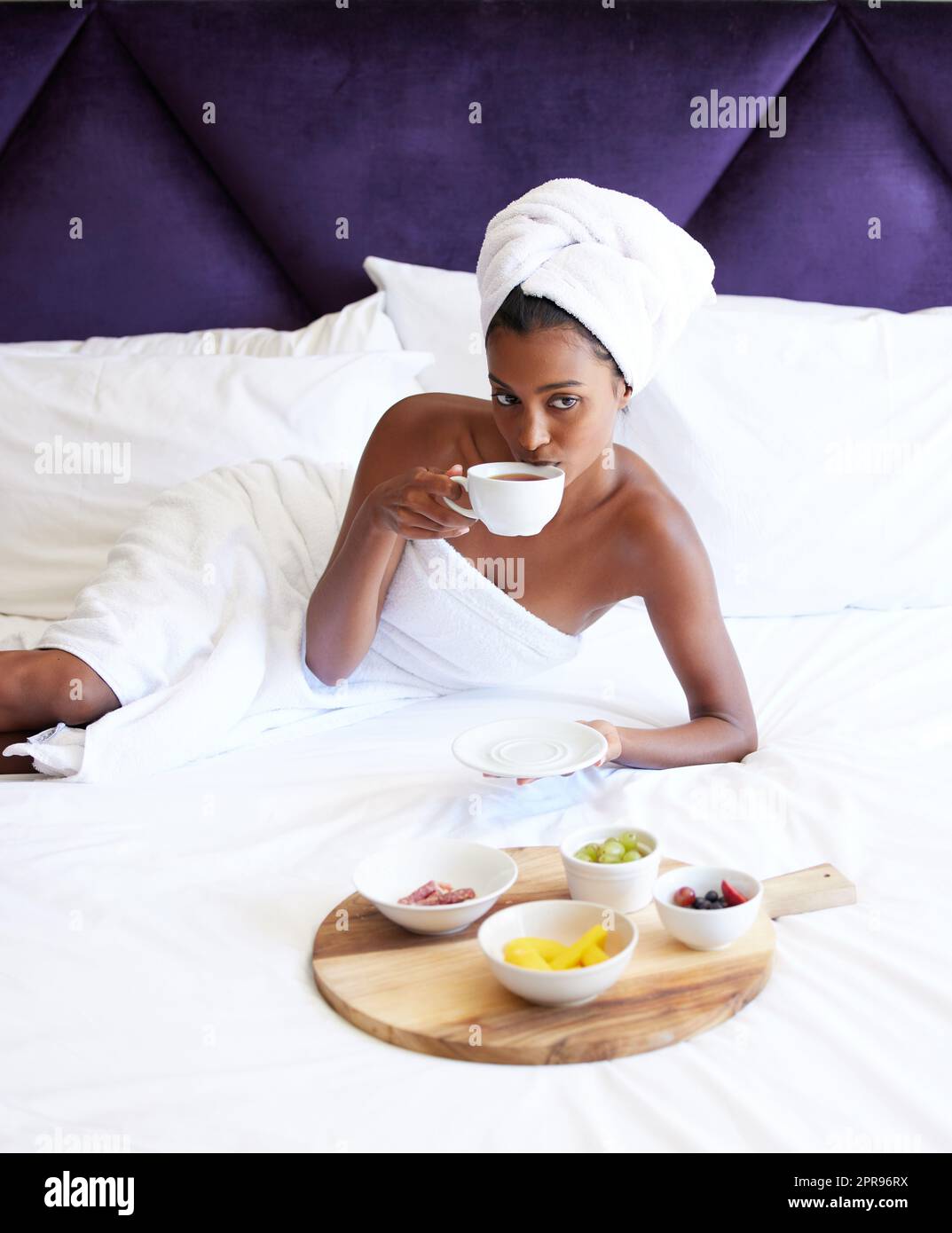 Breakfast in bed Dont mind if I do. Cropped portrait of an attractive young woman drinking tea